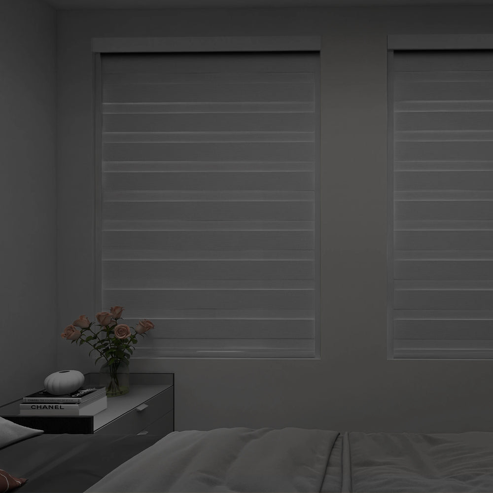 Blackout zebra shades in privacy mode creating a dim, sleep-friendly bedroom atmosphere