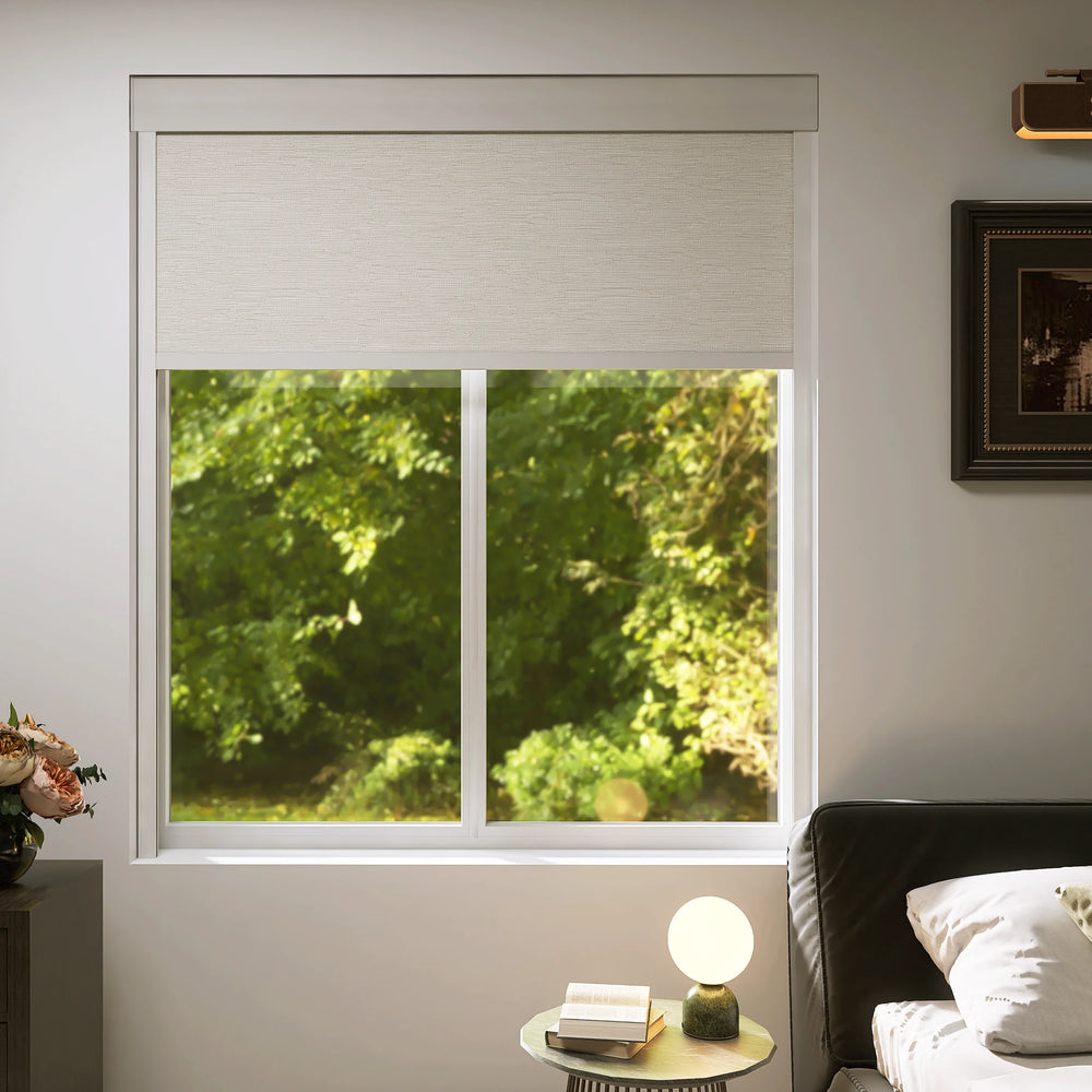 Motorized blackout roller shades half open in a cozy bedroom